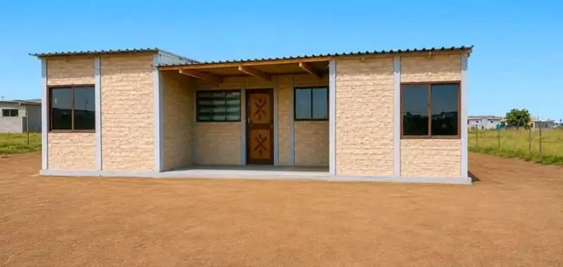 Precast house with shaded porch and brick walls